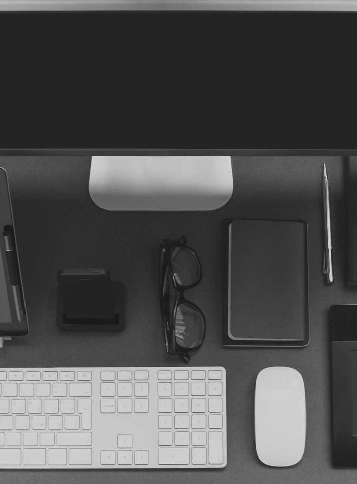 Minimal desk flat-lay with monitor, keyboard, and mouse