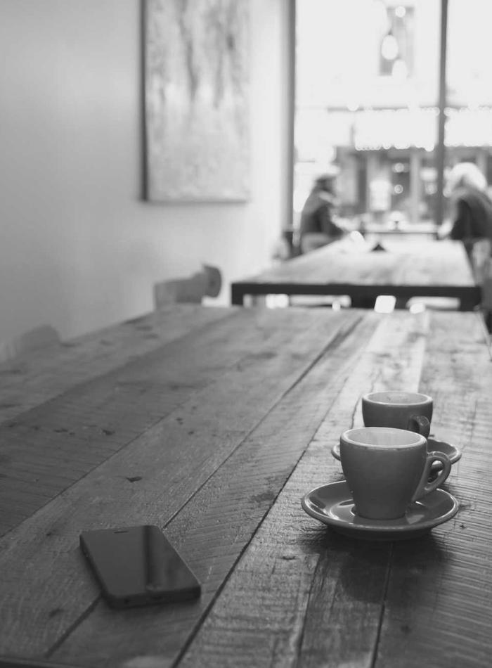 Café counter with two cups on a wooden table
